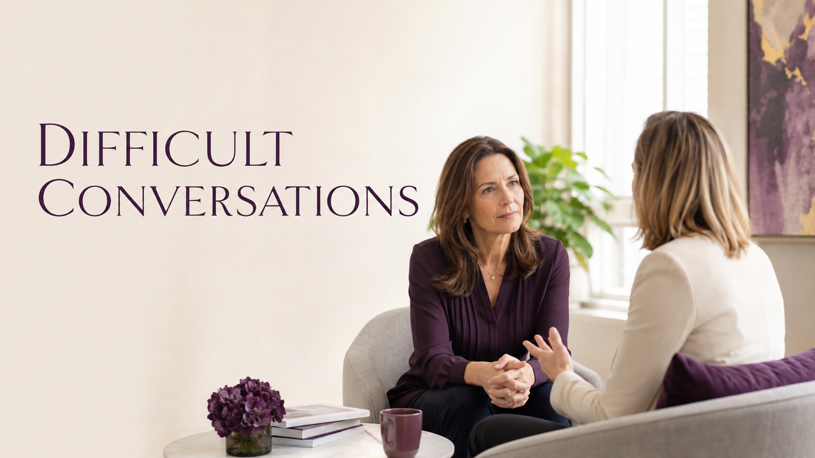 Two professional women having a focused and respectful conversation in a bright office, illustrating courageous leadership and difficult conversations.